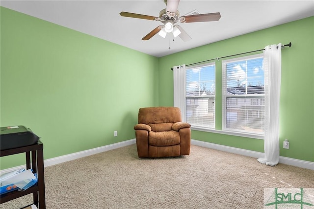 living area featuring ceiling fan and carpet