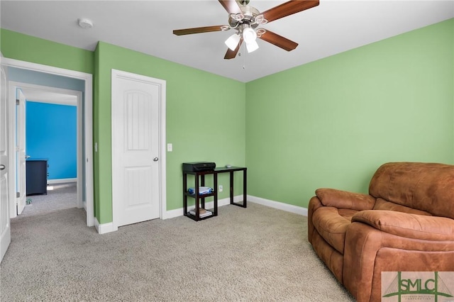 sitting room with ceiling fan and light colored carpet