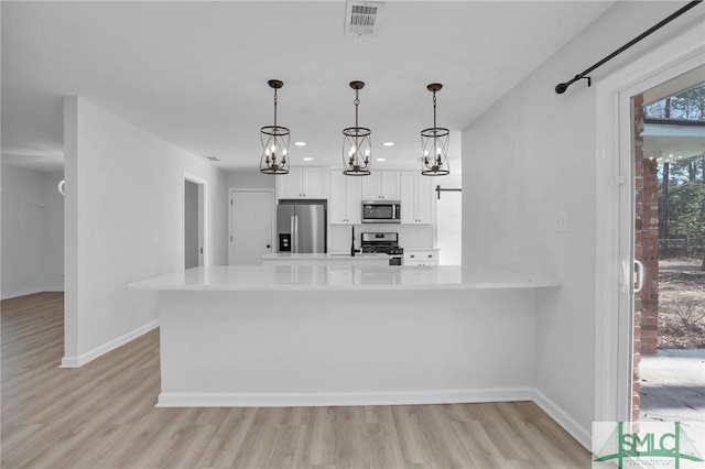 101 Cromwell Ct, Savannah, GA 31410 - kitchen featuring visible vents, light wood-type flooring, light countertops, white cabinetry, and appliances with stainless steel finishes