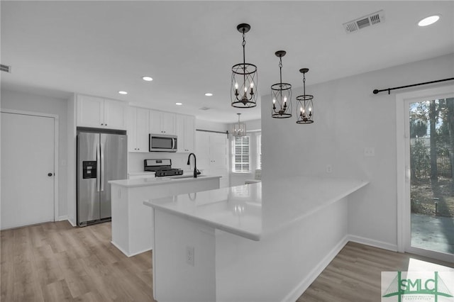 101 Cromwell Ct, Savannah, GA 31410 - kitchen featuring visible vents, light wood-type flooring, an inviting chandelier, stainless steel appliances, and recessed lighting
