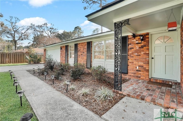 101 Cromwell Ct, Savannah, GA 31410 - entrance to property featuring fence, a garage, driveway, and brick siding