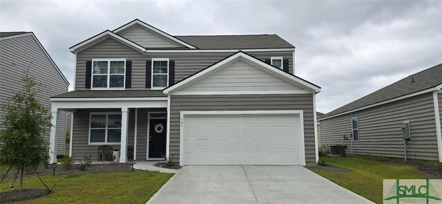 view of front of property featuring a garage, central AC, and a front lawn