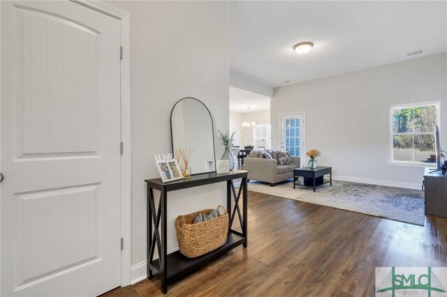 foyer entrance featuring a notable chandelier and hardwood / wood-style floors