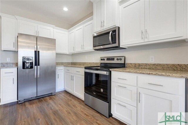 kitchen with white cabinetry, appliances with stainless steel finishes, dark hardwood / wood-style flooring, and light stone counters