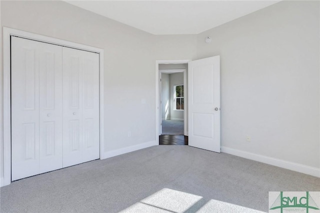 unfurnished bedroom featuring carpet flooring and a closet