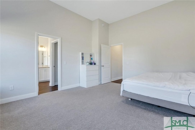 carpeted bedroom with high vaulted ceiling