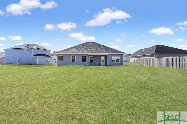 back of house with a lawn