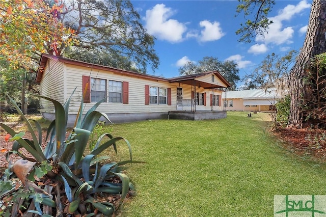 back of property featuring a lawn