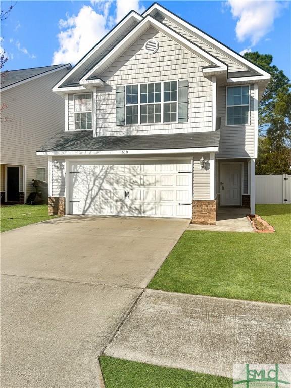 view of front of home with a garage and a front lawn