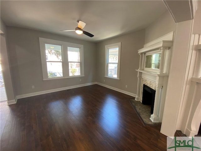 unfurnished living room with dark hardwood / wood-style flooring, a fireplace, and ceiling fan