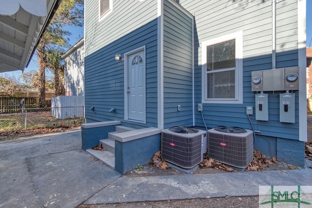 view of side of property with central AC