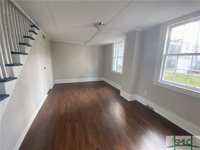 spare room featuring dark wood-type flooring