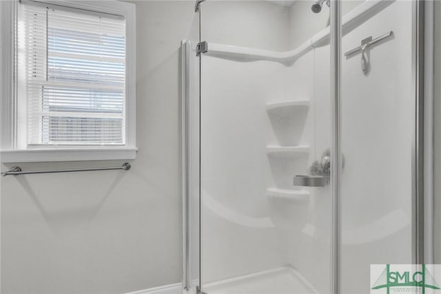 bathroom with a shower with shower door