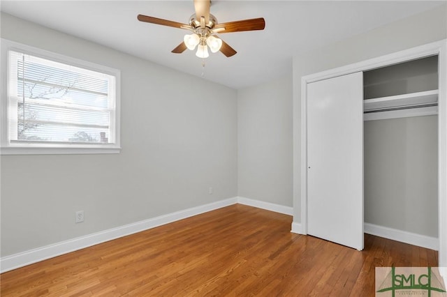 unfurnished bedroom featuring wood-type flooring, a closet, and ceiling fan