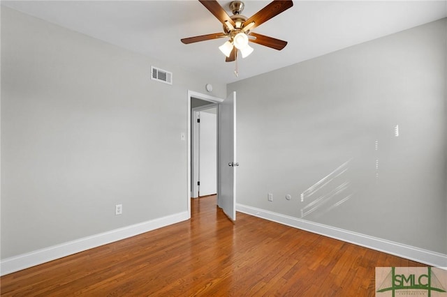 empty room featuring hardwood / wood-style floors and ceiling fan