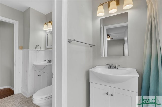 bathroom with ceiling fan, vanity, and toilet