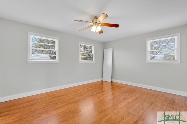 empty room with ceiling fan and light hardwood / wood-style flooring