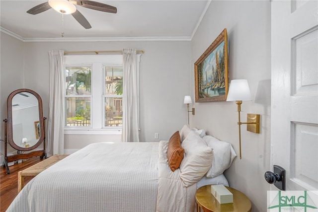 bedroom featuring hardwood / wood-style flooring, crown molding, and ceiling fan