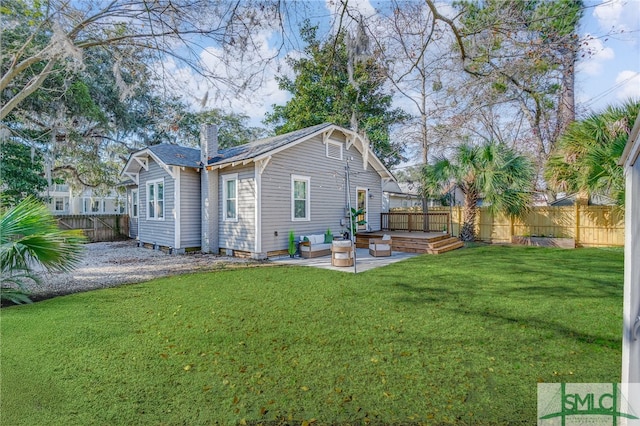 back of house with a patio area and a lawn