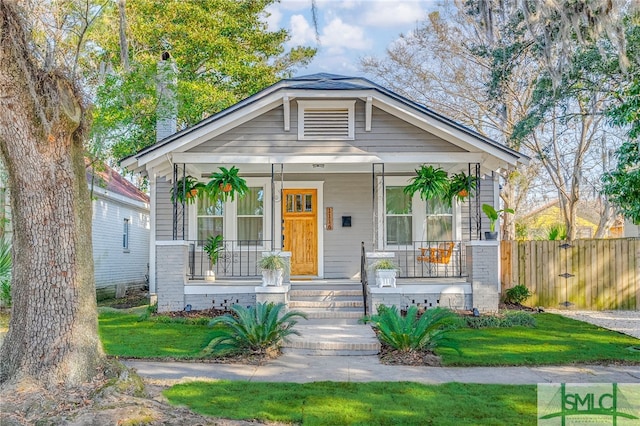 bungalow featuring a porch and a front yard