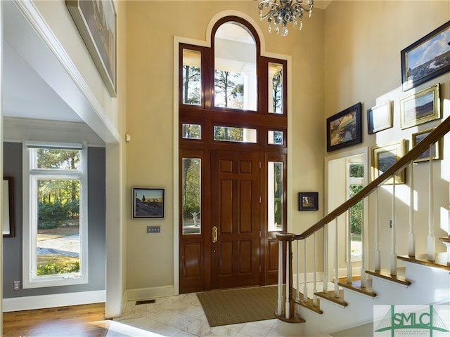 foyer with a notable chandelier and a towering ceiling