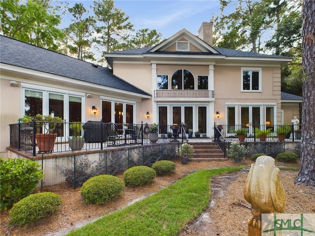 back of house with a balcony