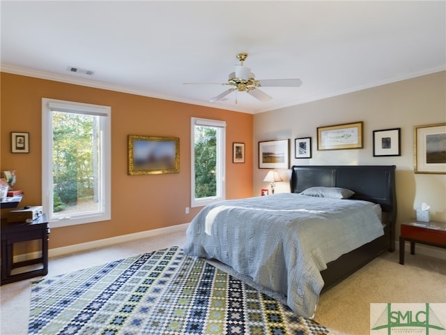 carpeted bedroom with multiple windows, ornamental molding, and ceiling fan