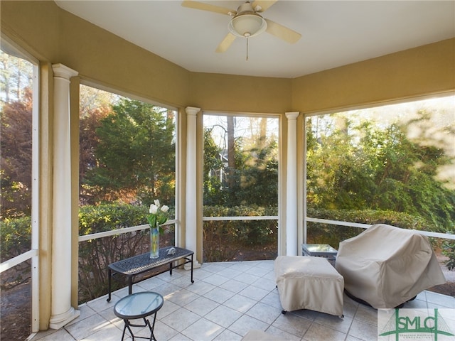 sunroom featuring ornate columns and ceiling fan