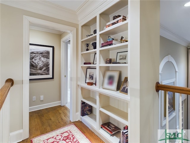 room details featuring ornamental molding, hardwood / wood-style floors, and built in features