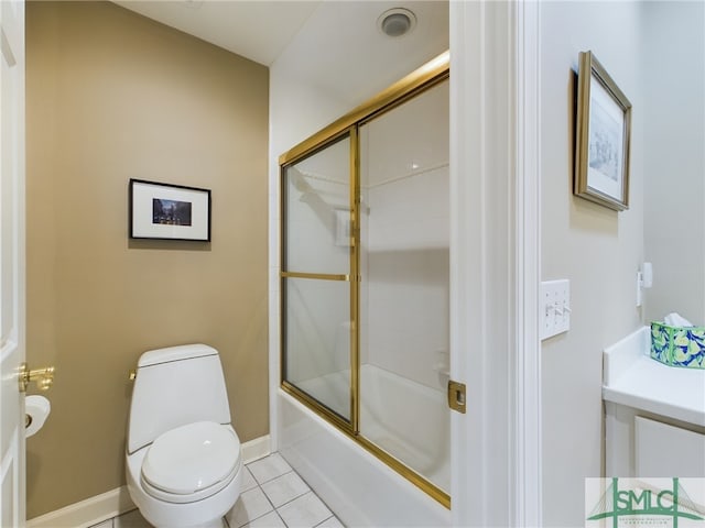 bathroom with tile patterned flooring, toilet, and combined bath / shower with glass door