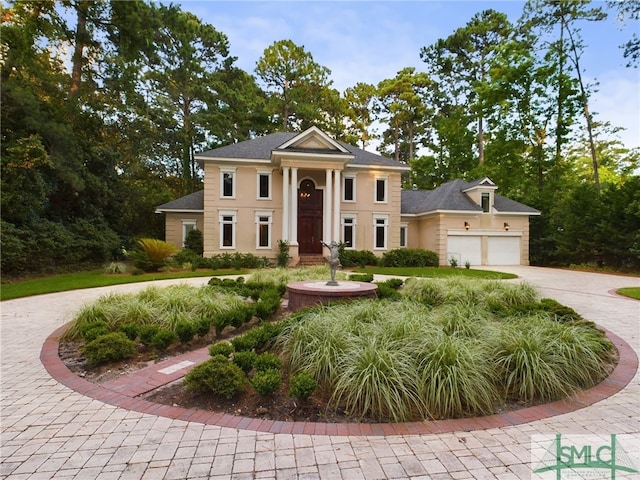 neoclassical home featuring a garage