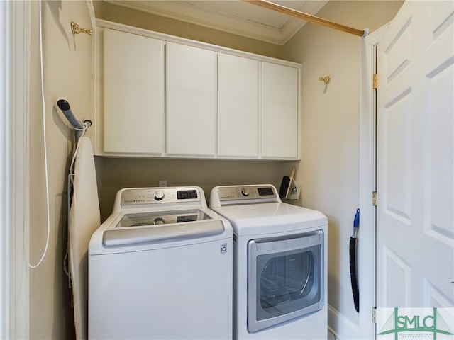 laundry area with washer and clothes dryer and cabinets