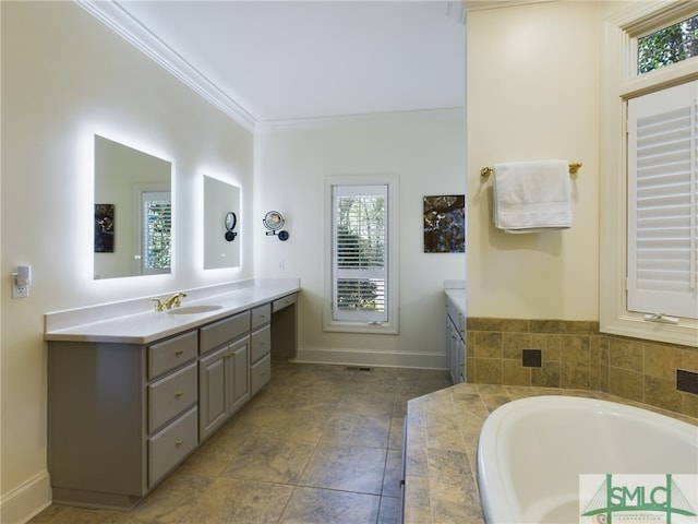 bathroom with vanity, crown molding, and tiled bath