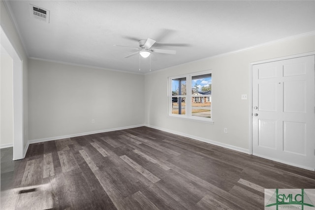 spare room with dark hardwood / wood-style flooring, crown molding, and ceiling fan