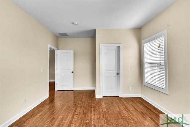 unfurnished bedroom with hardwood / wood-style floors