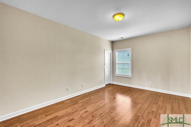 spare room with hardwood / wood-style floors