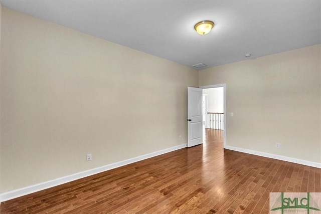 spare room with wood-type flooring