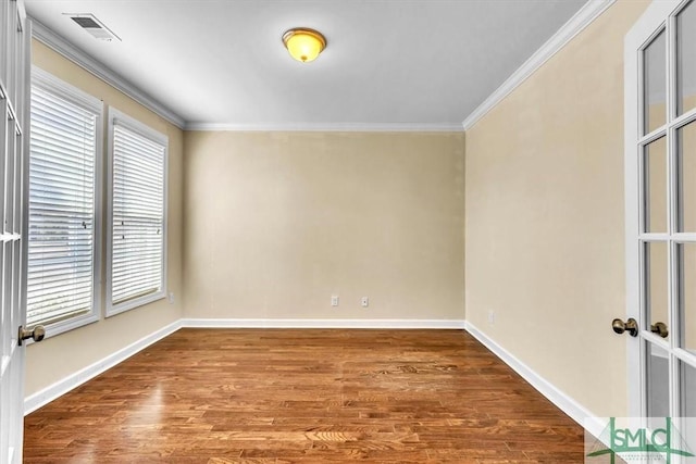 unfurnished room featuring hardwood / wood-style flooring, ornamental molding, and french doors