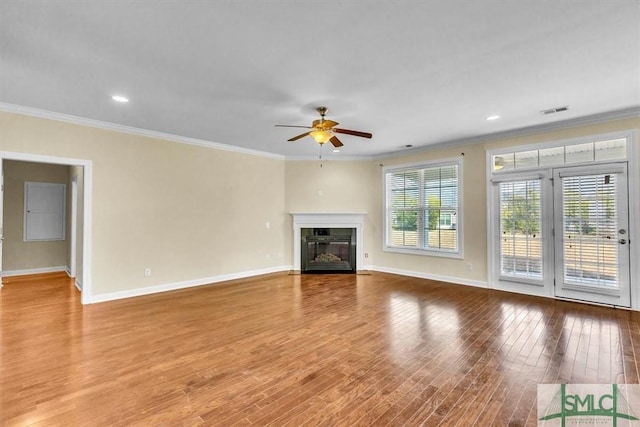 unfurnished living room with wood-type flooring, ceiling fan, and crown molding