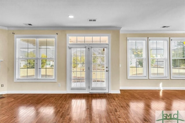 doorway featuring hardwood / wood-style flooring and ornamental molding