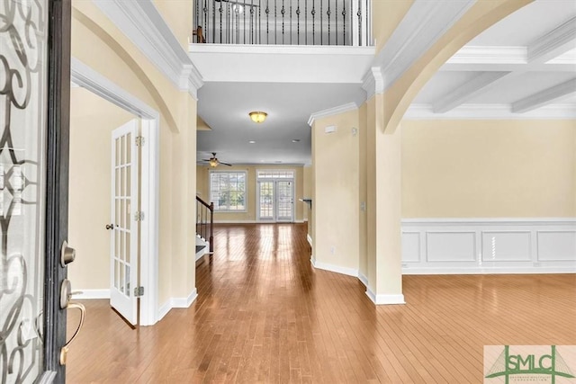 entryway with coffered ceiling, crown molding, ceiling fan, beam ceiling, and hardwood / wood-style floors