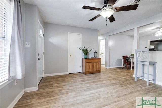 entryway with ceiling fan and light wood-type flooring