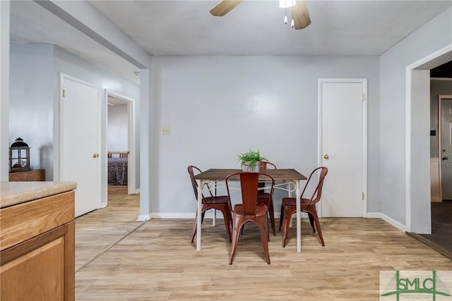 dining area featuring ceiling fan and light wood-type flooring