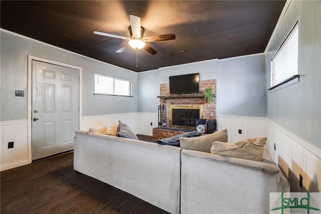 living room with ceiling fan, dark hardwood / wood-style floors, and a fireplace