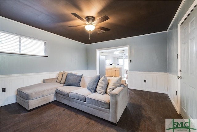 living room featuring ceiling fan, ornamental molding, and dark hardwood / wood-style flooring