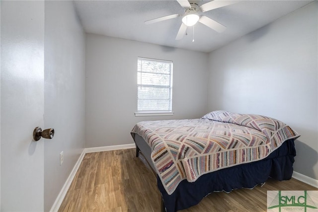 bedroom featuring hardwood / wood-style floors and ceiling fan