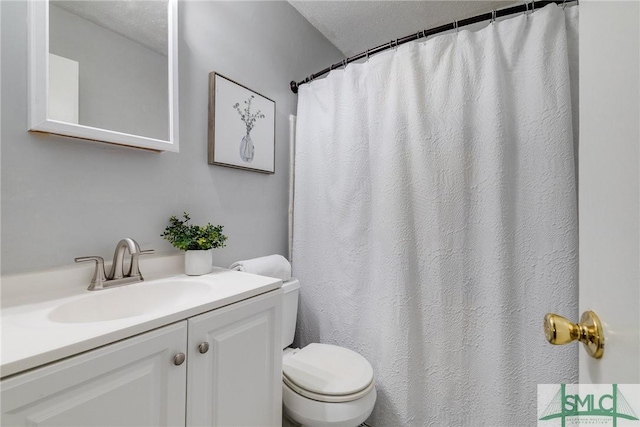 bathroom featuring vanity, toilet, and walk in shower