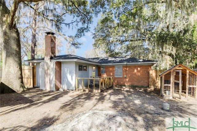 rear view of house with an outdoor structure