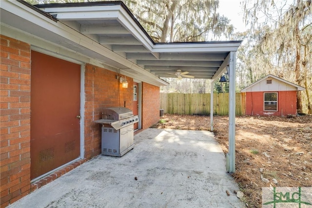 view of patio / terrace with a grill, a storage shed, and ceiling fan