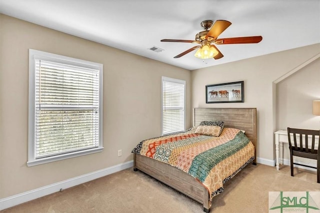 carpeted bedroom with ceiling fan and multiple windows